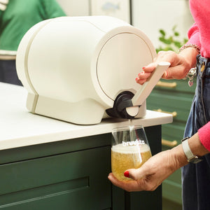Pouring a glass of freshly brewed, homemade kombucha from the bruusta tap